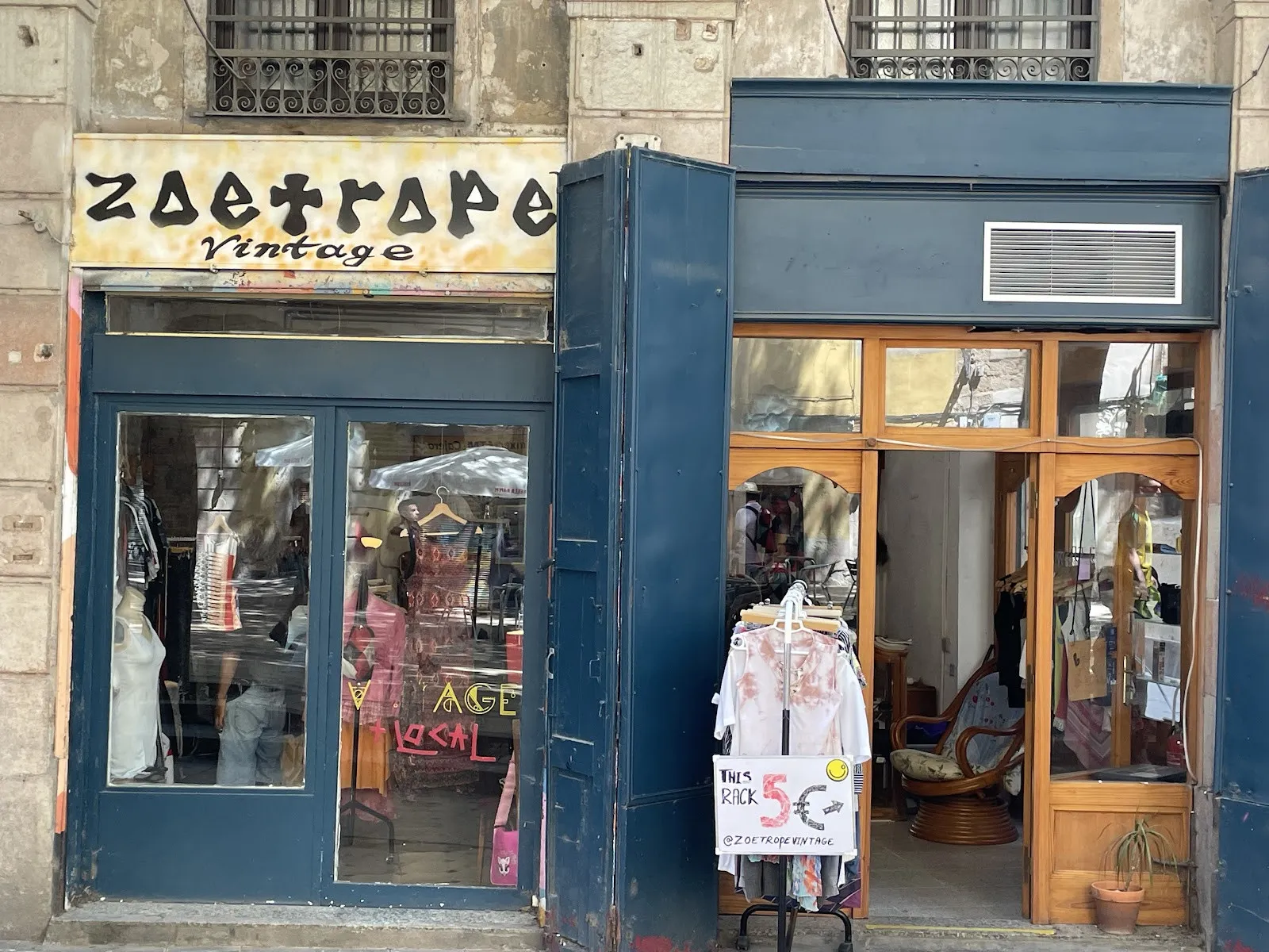 The blue doors of Zoetrope Vintage on Plaça de Sant Agustí Vell, with its sign above